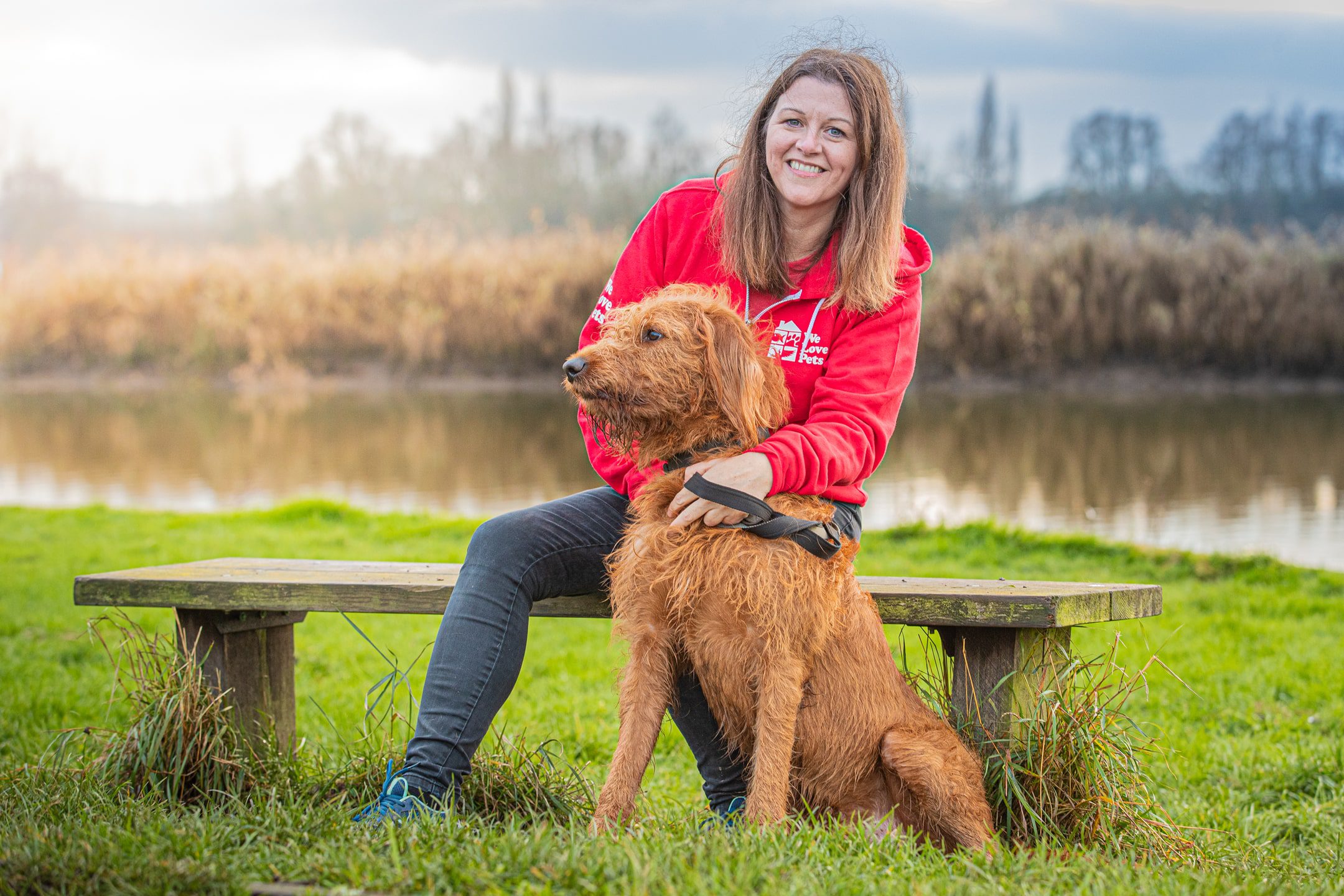 Julie from We Love Pets Bolton sitting with a dog