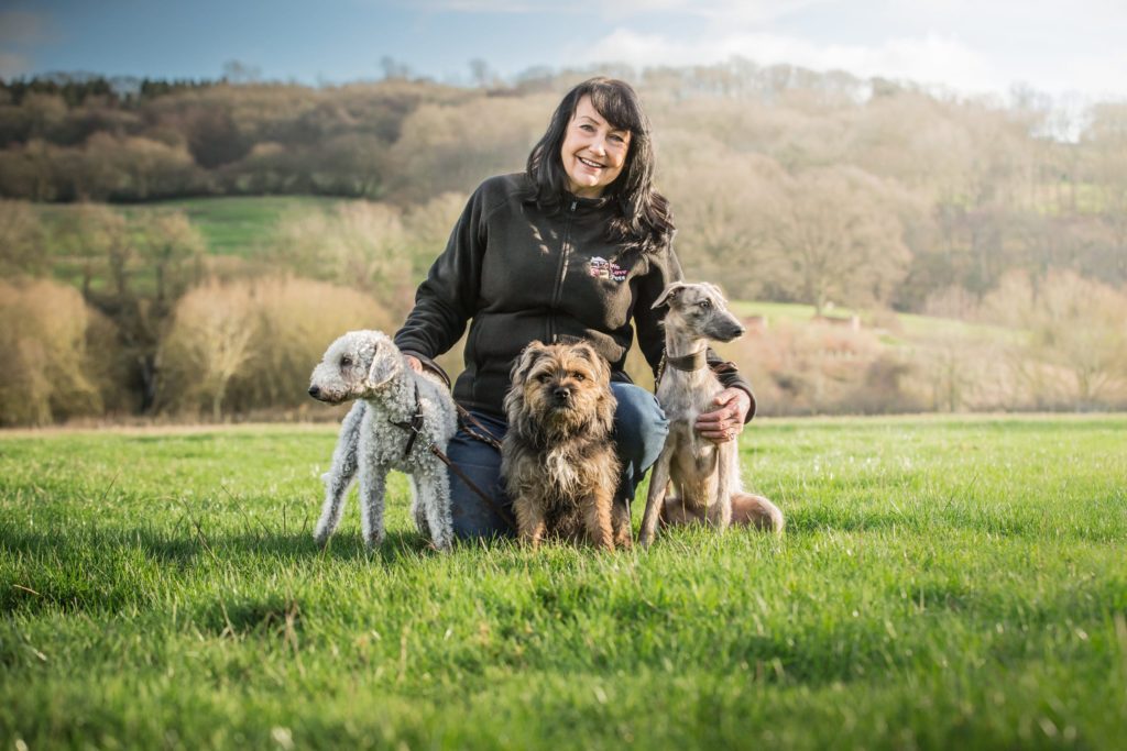 Andrea from We Love Pets Sutton with three dogs