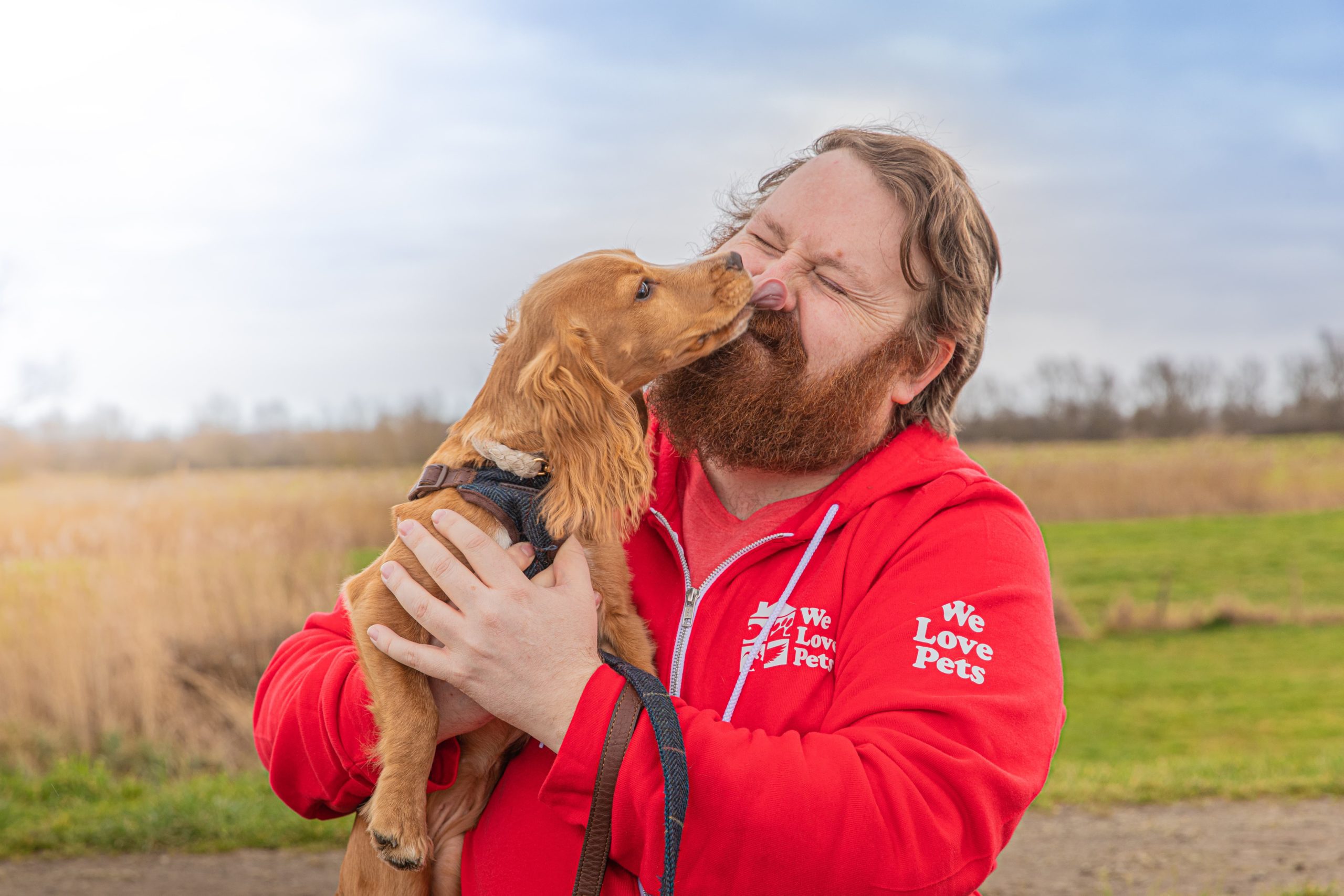 Dog licking a mans face