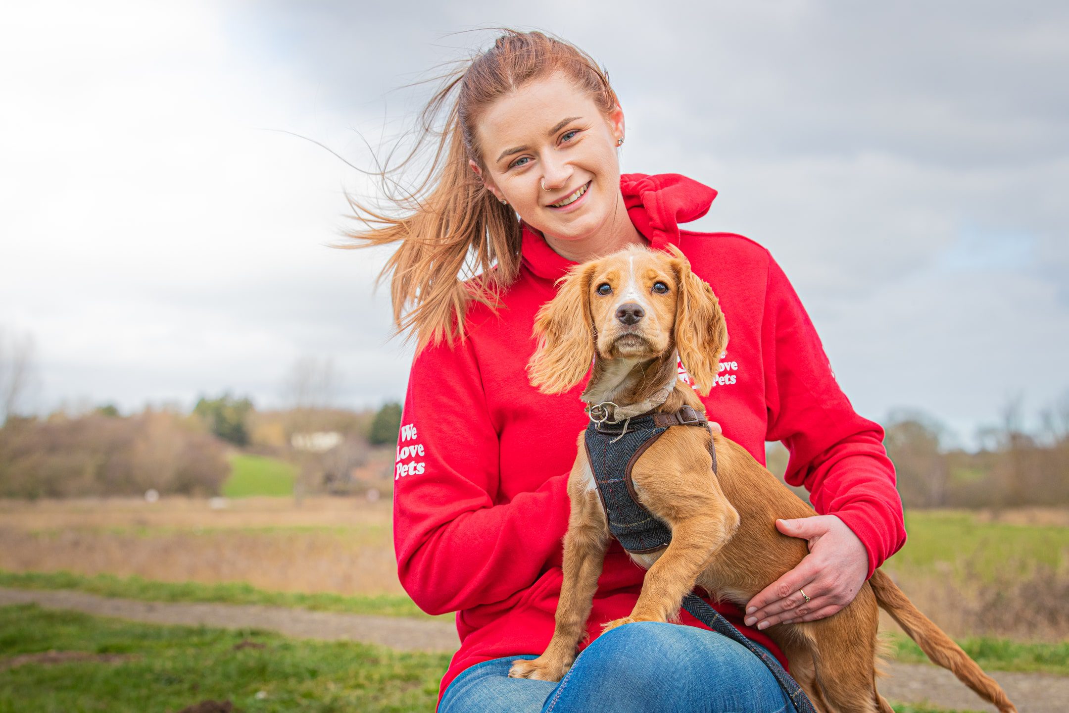 Louise from We Love Pets Epsom with a dog on her lap