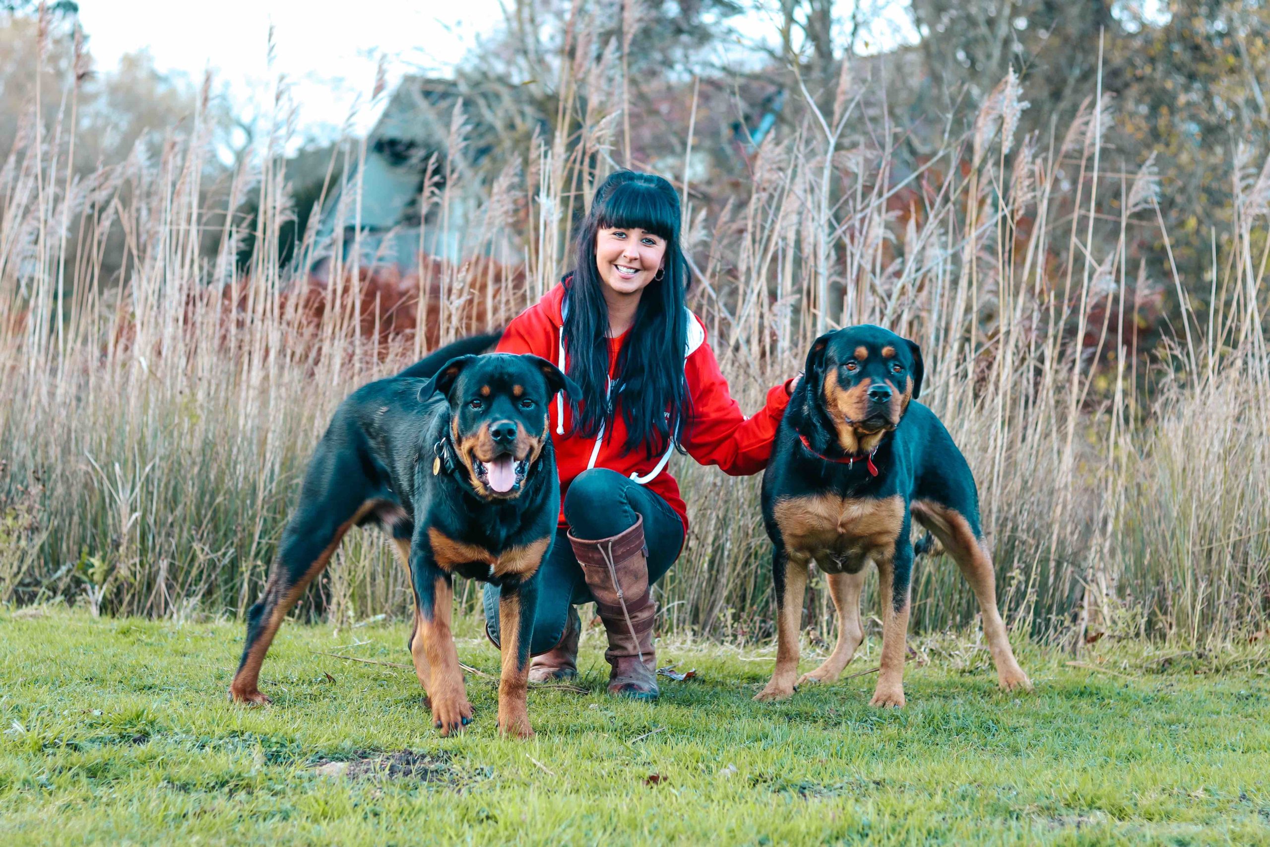 Danielle from We Love Pets kneeling with two dogs