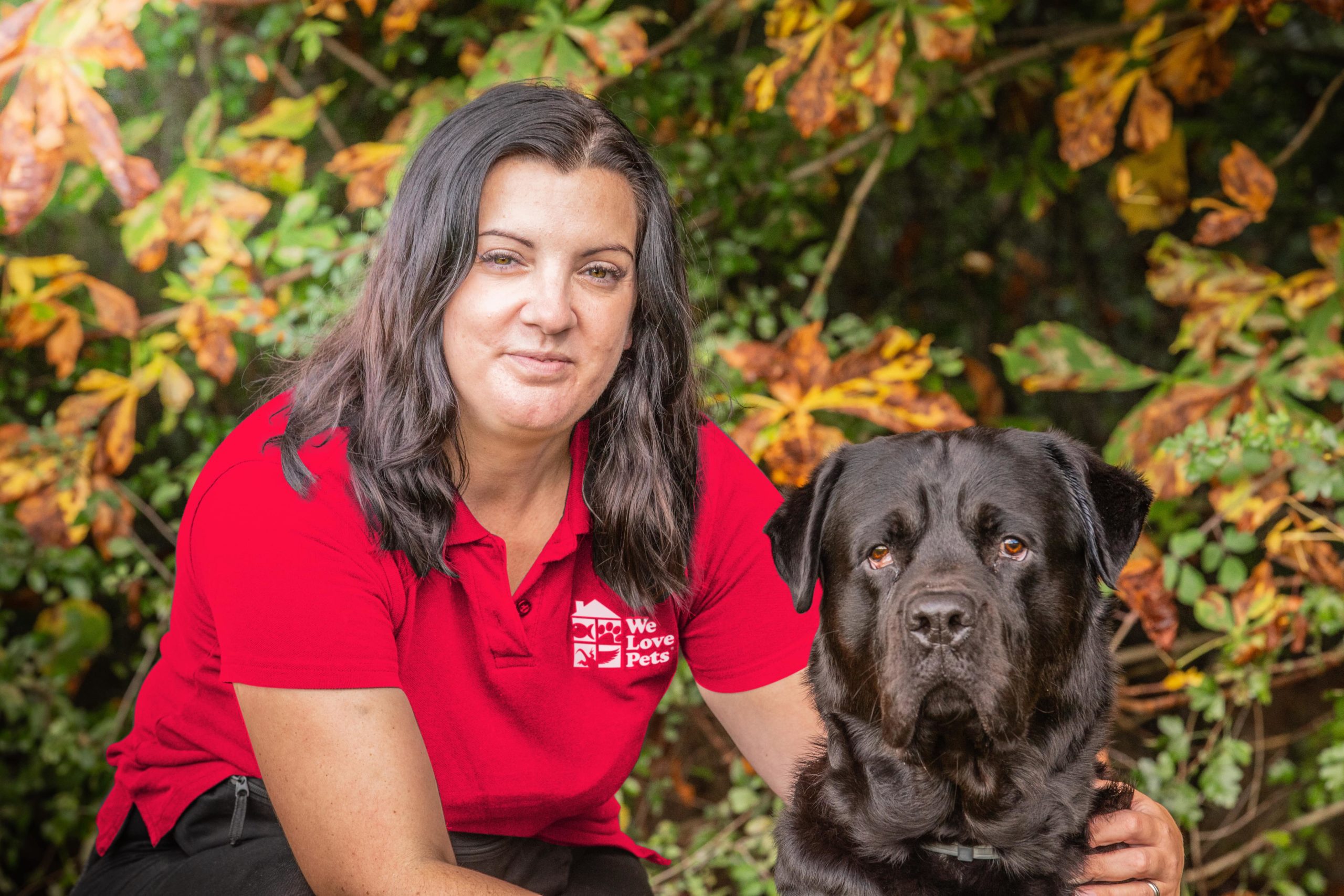 Jo from Trowbridge kneeling next to a dog