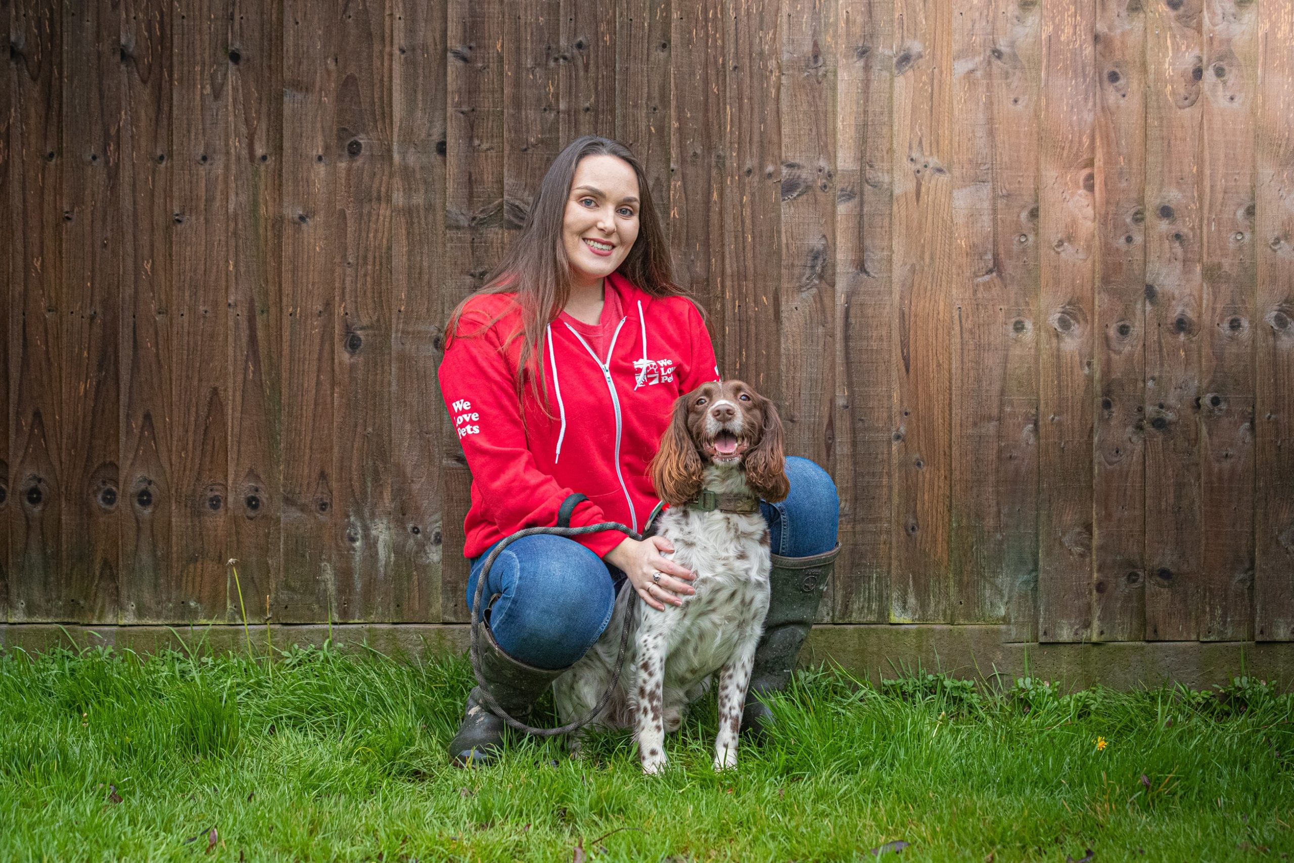 Lucy from We Love Pets Kidderminster crouching with a happy dog