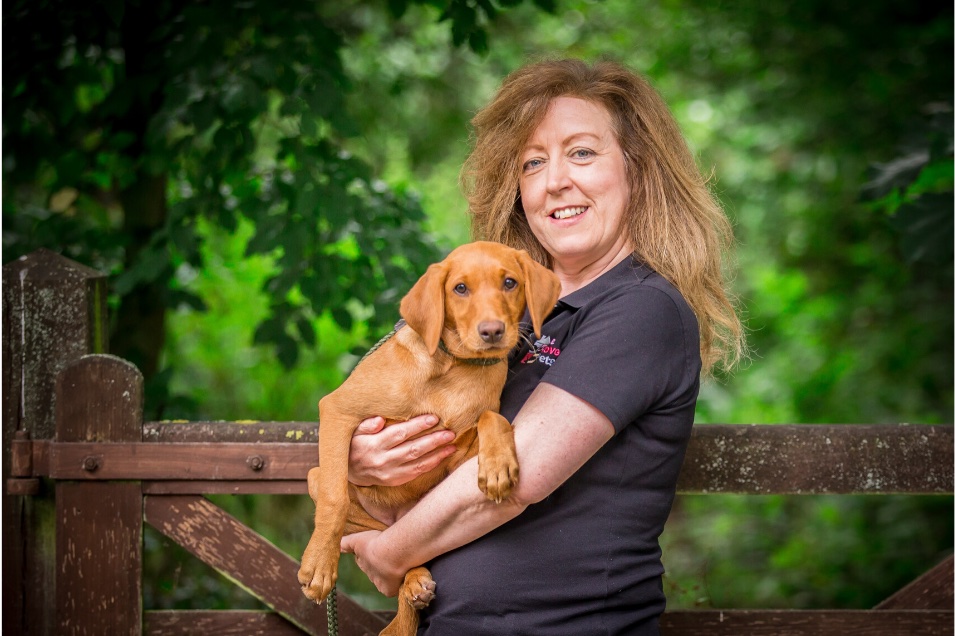 Woman from We Love Pets Winnersh holding a puppy in her arms