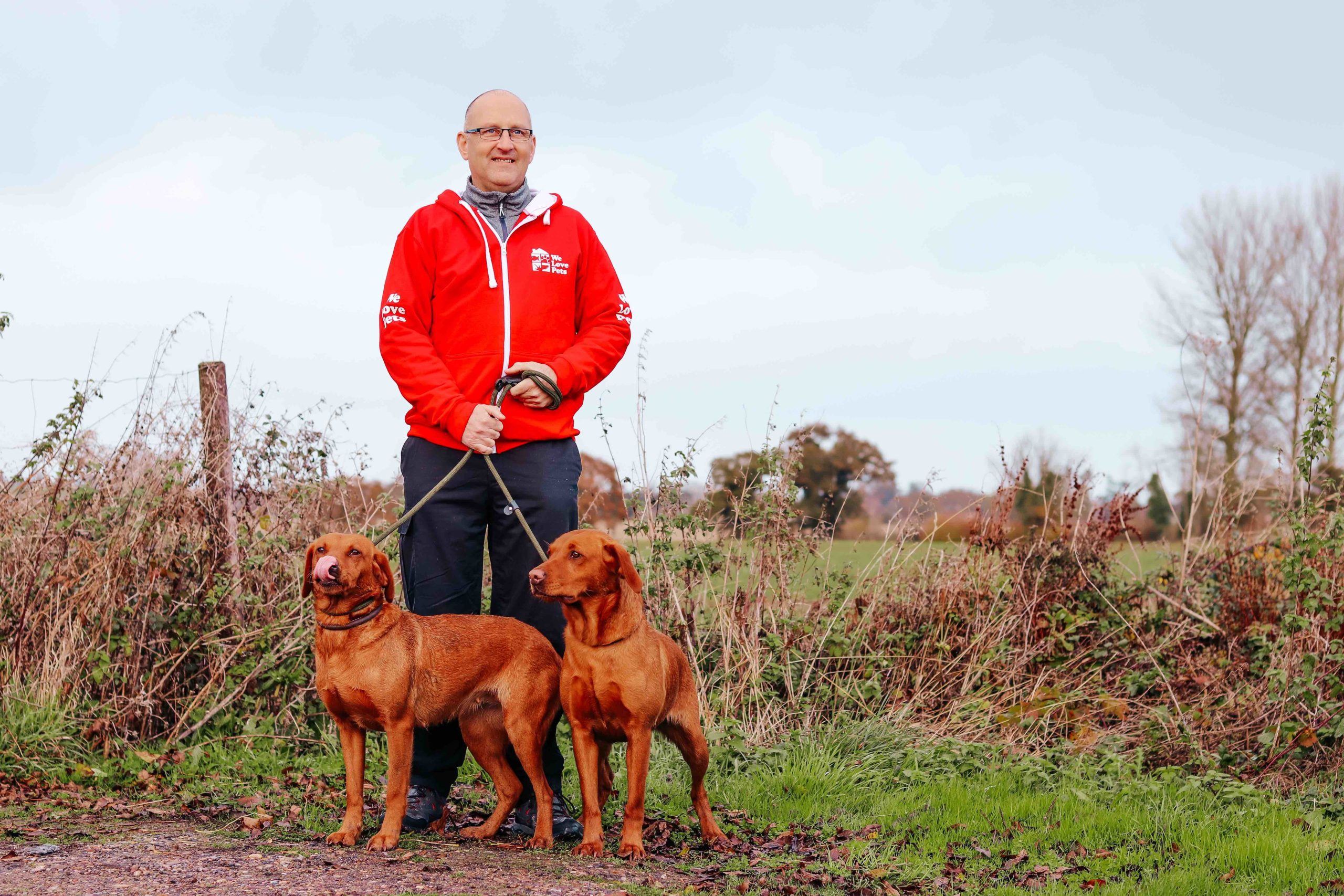 Alec from We Love Pets walking two dogs on leads