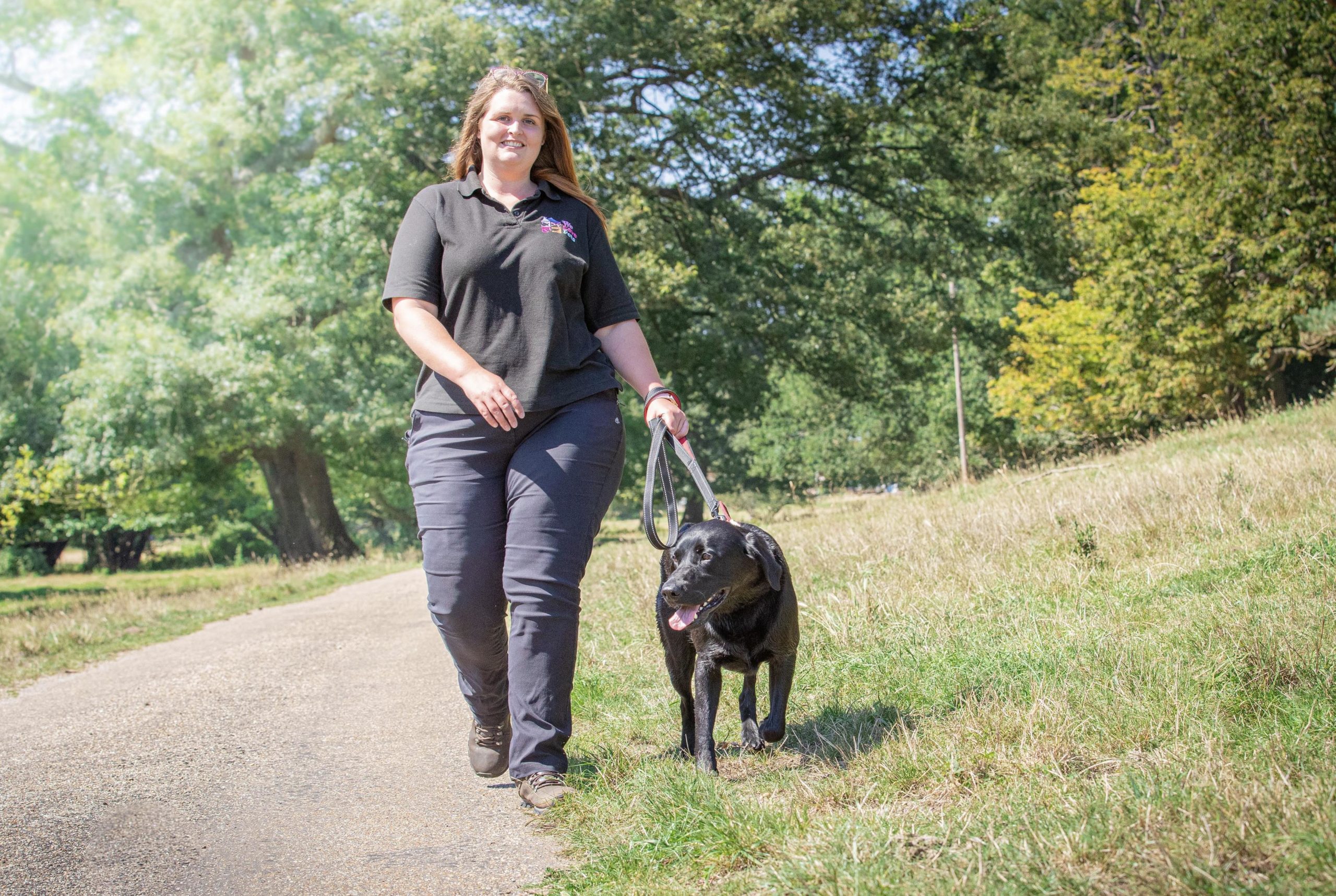 Emma from We Love Pets Bridgend walking with a dog