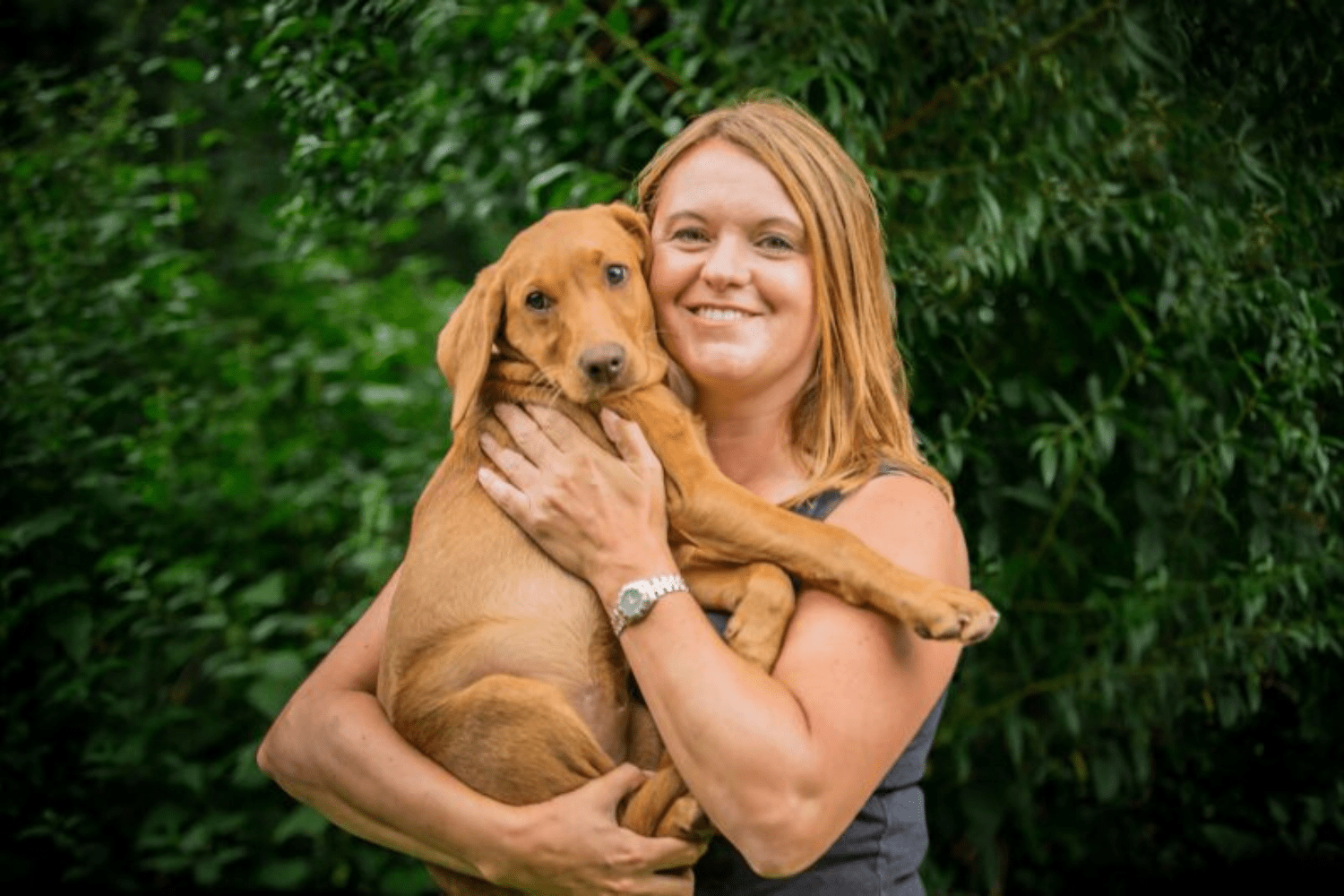 Woman hugging puppy