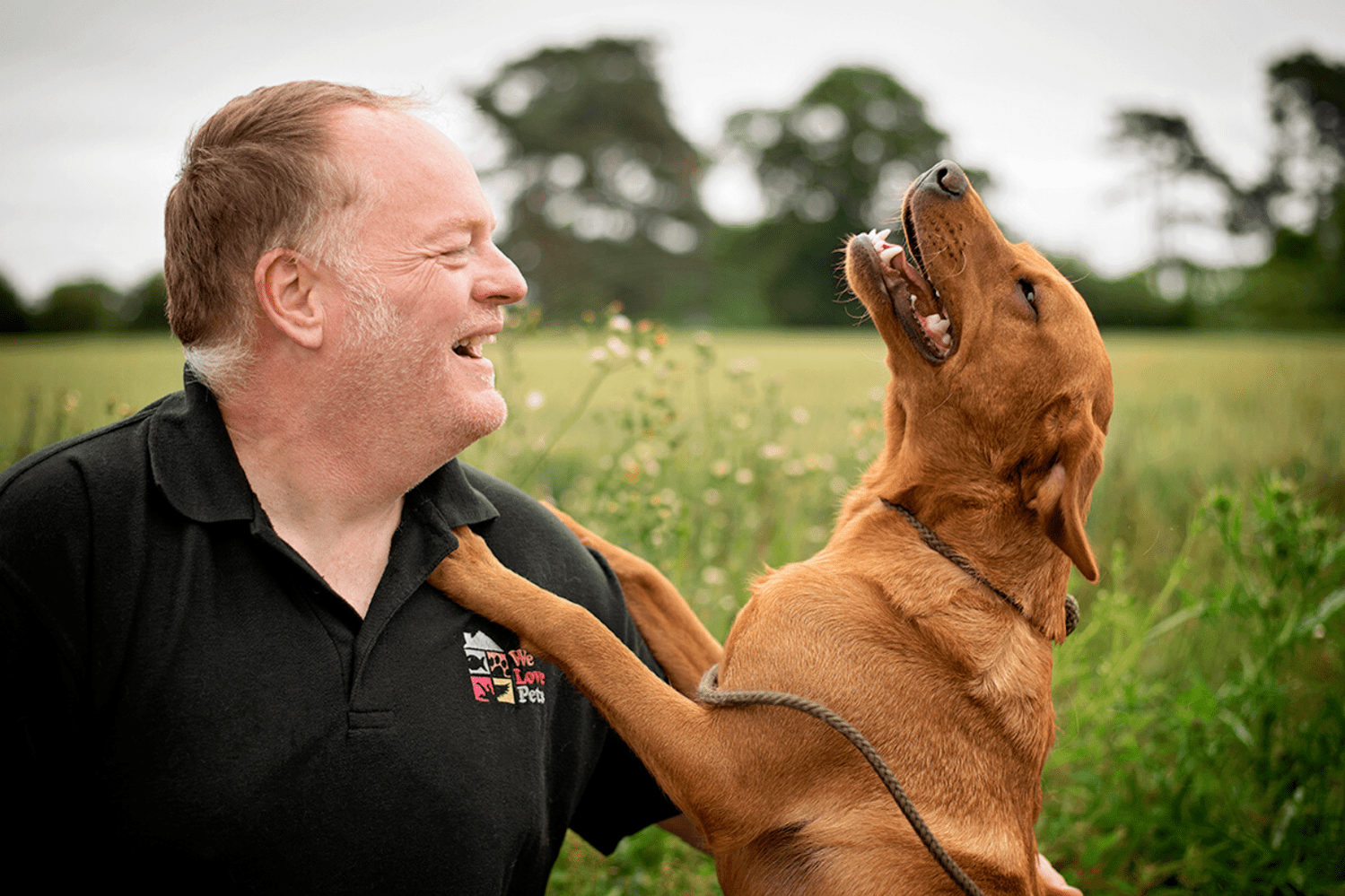 Paul from We Love Pets laughing with dog