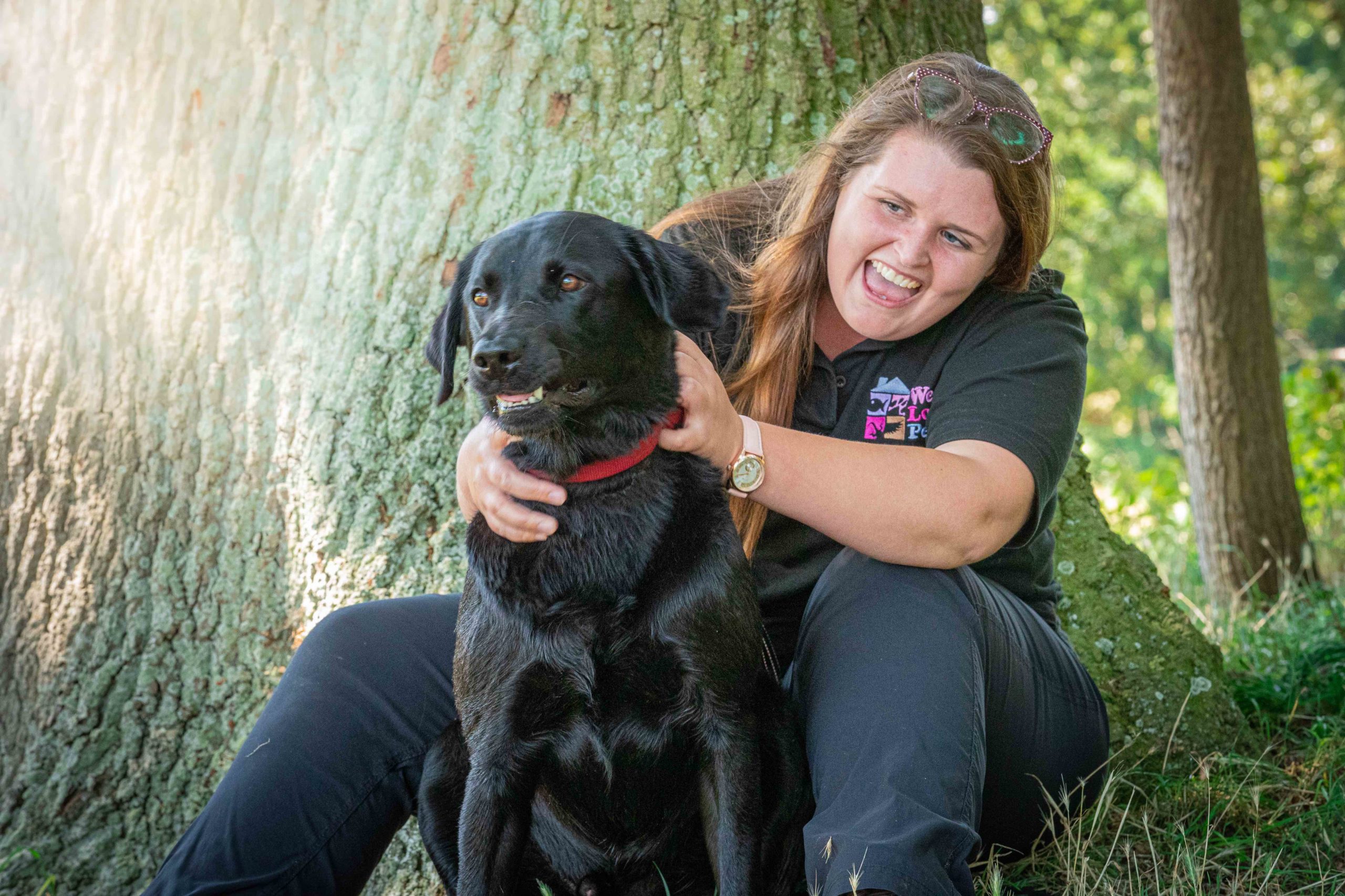 Woman sat with dog in her lap