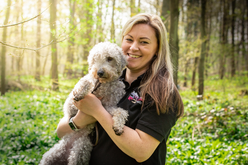 Smiling woman holding a dog