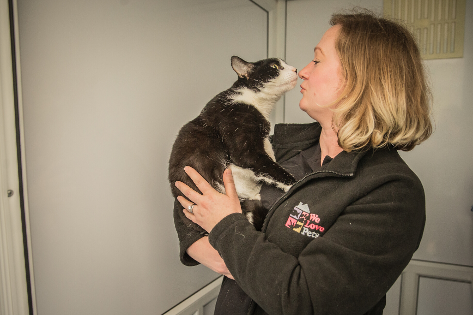 Woman from We Love Pets Twyford kissing cat in her arms